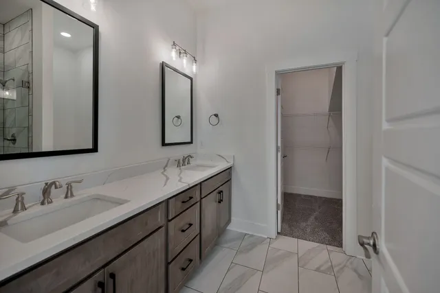 a bathroom with a granite countertop sink mirror and double