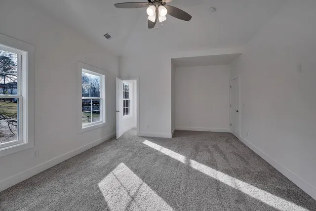 a view of a livingroom with a chandelier fan