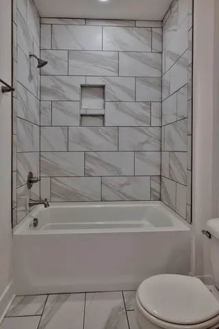 a bathroom with a toilet and a bathtub