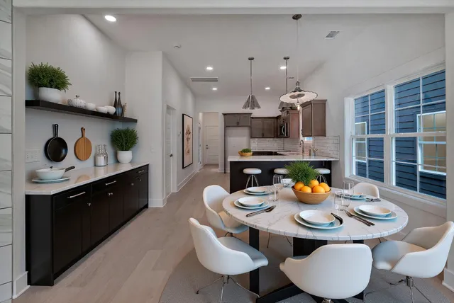 a kitchen with a sink a stove and chairs
