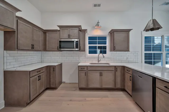 a kitchen with stainless steel appliances granite countertop a sink and cabinets