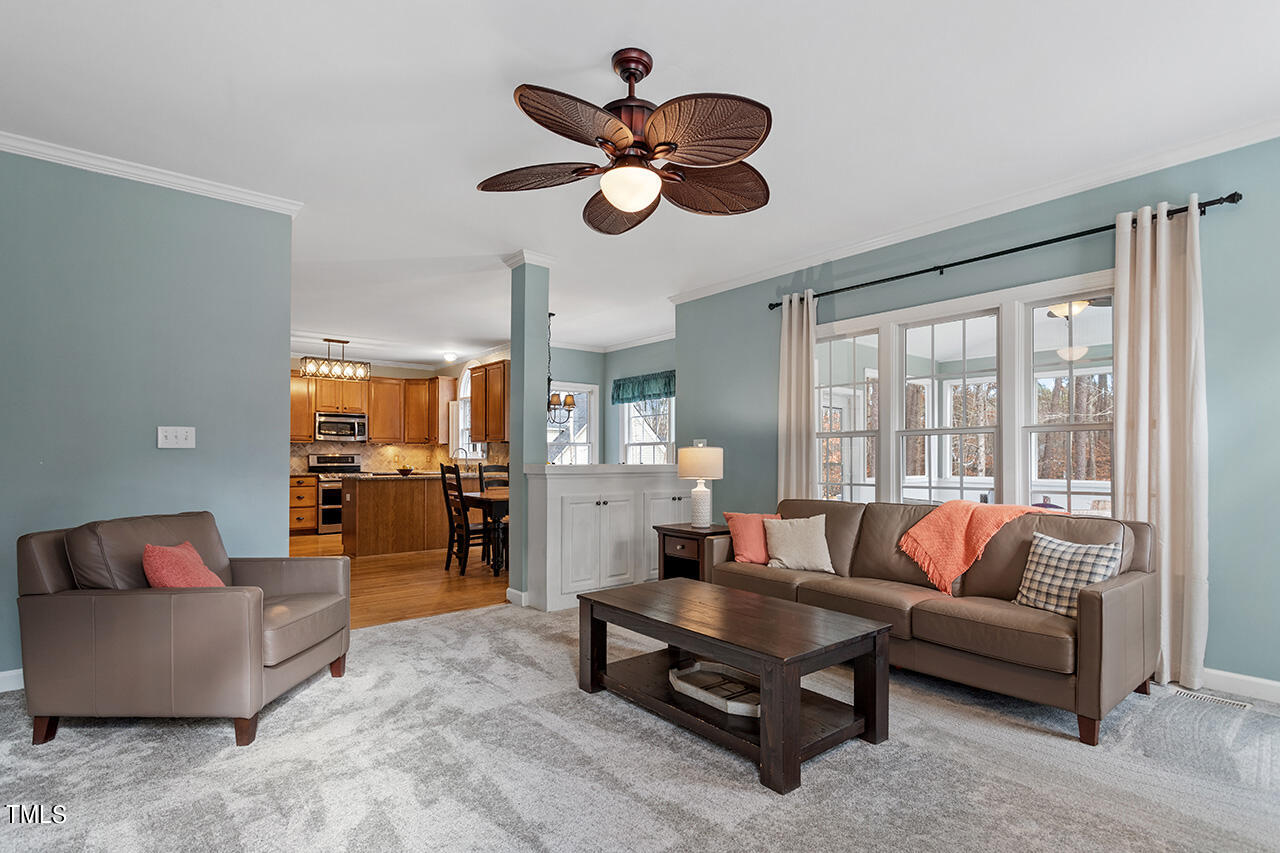 2709 Dray Court Raleigh, NC 27613 - Photo 18 of 51 a living room with furniture ceiling fan and a rug