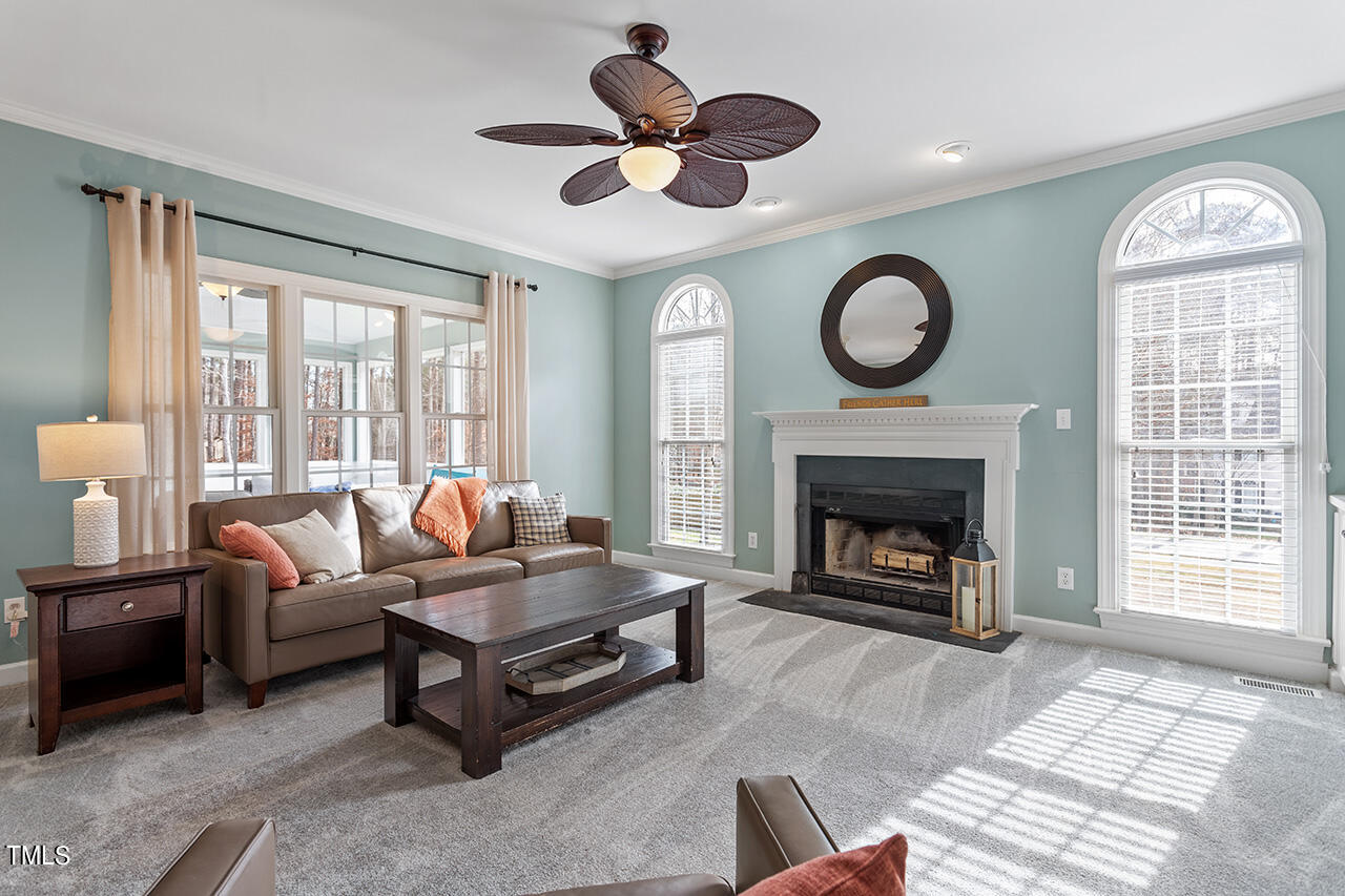 2709 Dray Court Raleigh, NC 27613 - Photo 2 of 51 a living room with furniture a fireplace and a large window