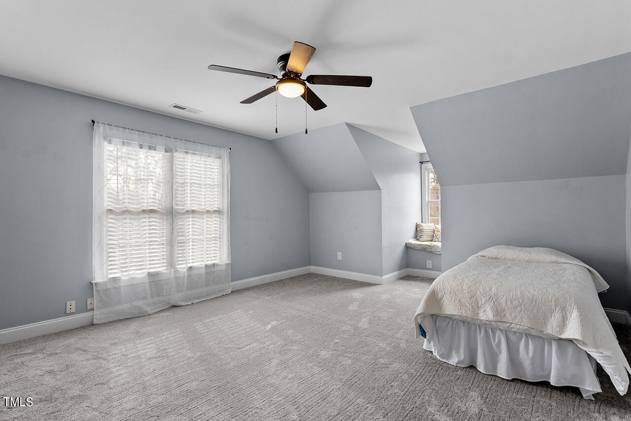 2709 Dray Court Raleigh, NC 27613 - Photo 32 of 51 a spacious bedroom with a bed and a large window