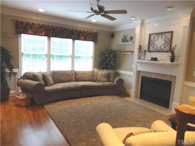 9321 Stone Mountain Road Raleigh, NC 27613 - Photo 9 of 25 a living room with furniture and a fireplace
