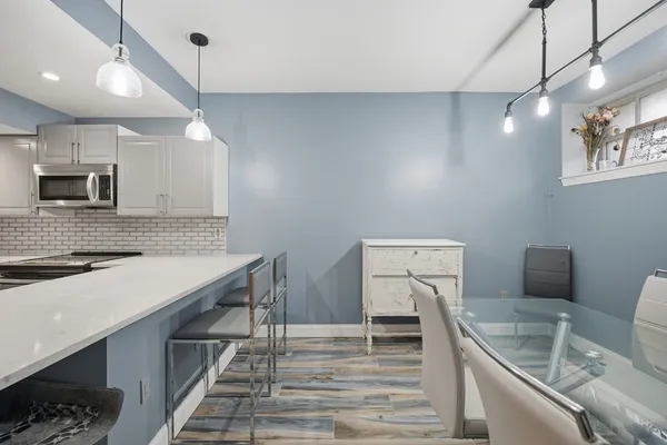 a kitchen with a sink cabinets and wooden floor