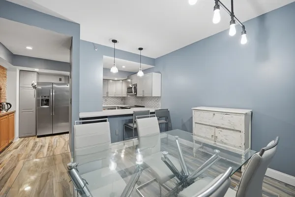 a kitchen with cabinets and chairs
