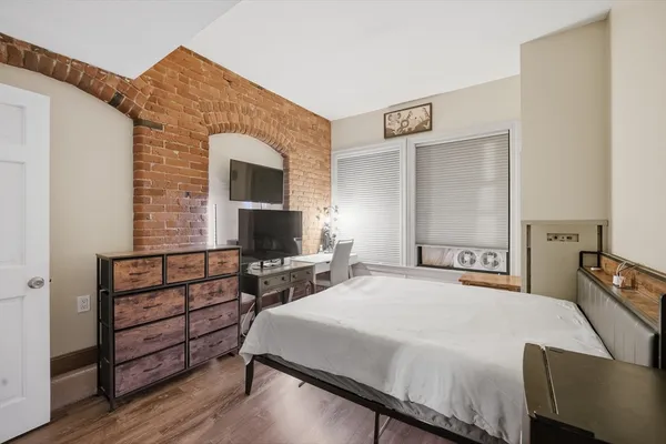 a bedroom with a bed and a flat screen tv