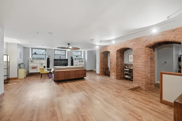 a bedroom with furniture and a wooden floor