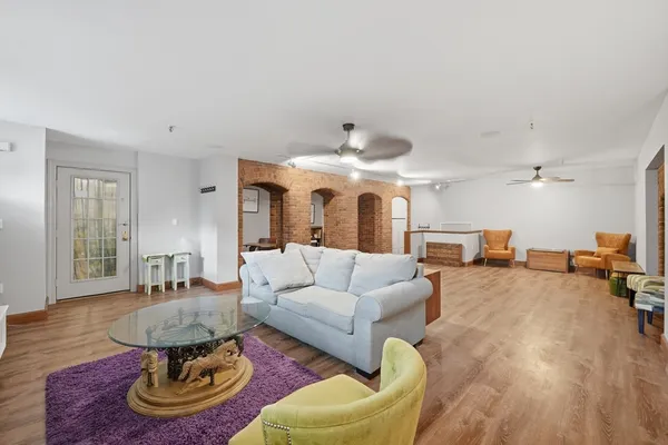 a living room with furniture and a chandelier