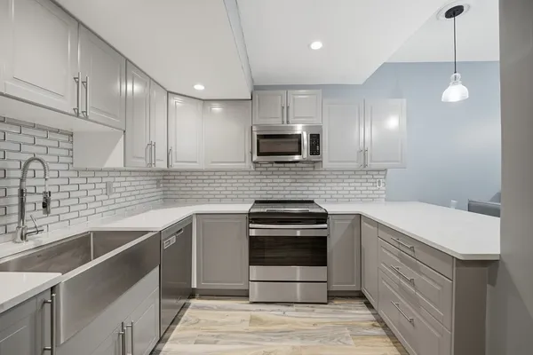 a kitchen with a sink cabinets and stainless steel appliances