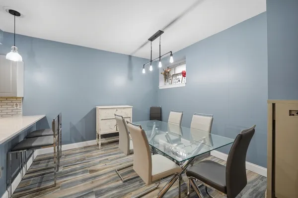 a view of a dining room with furniture and wooden floor