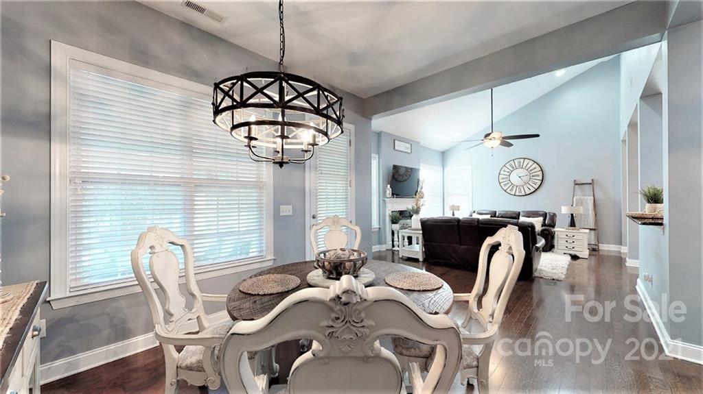 2007 Fallondale Road Waxhaw, NC 28173 - Photo 23 of 48 a view of a dining room with furniture a chandelier and wooden floor
