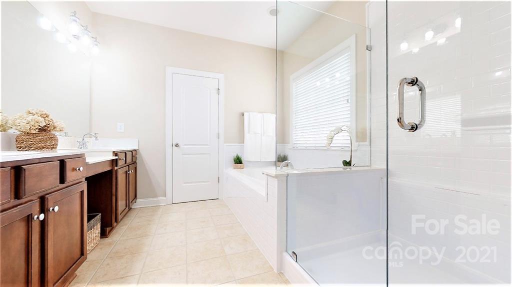2007 Fallondale Road Waxhaw, NC 28173 - Photo 32 of 48 a large bathroom with a double vanity sink a mirror and a shower