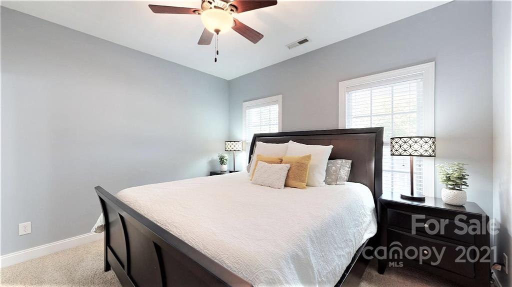2007 Fallondale Road Waxhaw, NC 28173 - Photo 37 of 48 a bedroom with a large bed and a chandelier