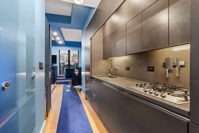 a kitchen with stainless steel appliances granite countertop a refrigerator and a stove
