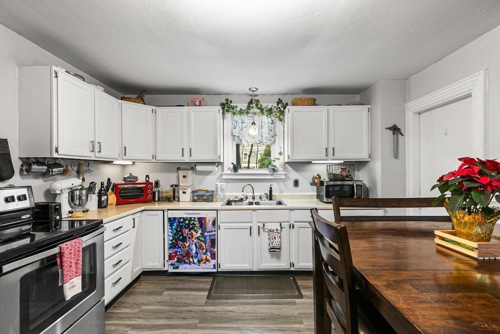 61 Church Street Merrimac, MA 01860 - Photo 3 of 32 a kitchen with stainless steel appliances granite countertop sink stove top oven and cabinets