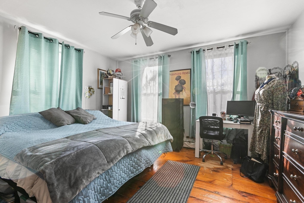 61 Church Street Merrimac, MA 01860 - Photo 4 of 32 a bedroom with a bed and a chandelier
