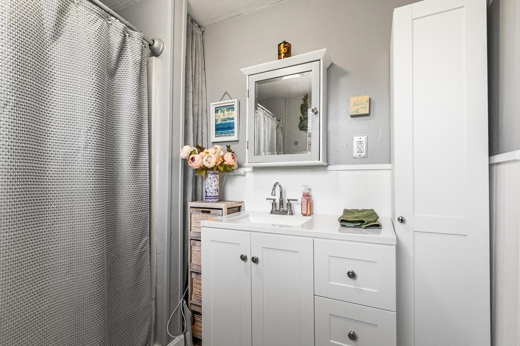 61 Church Street Merrimac, MA 01860 - Photo 7 of 32 a bathroom with a sink vanity and mirror