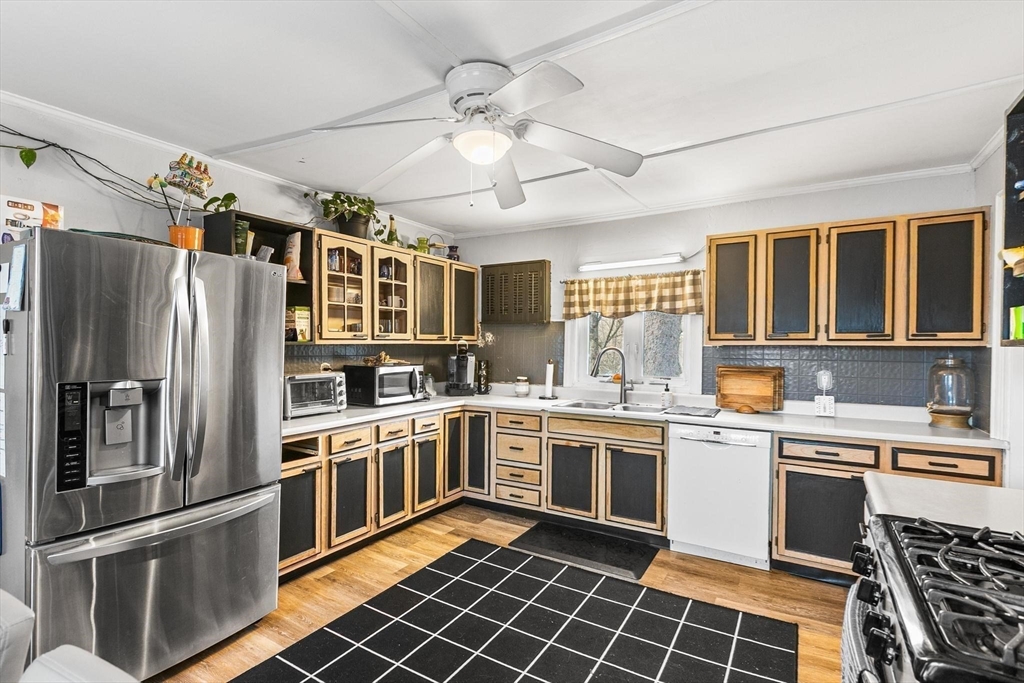 61 Church Street Merrimac, MA 01860 - Photo 9 of 32 a kitchen with stainless steel appliances a stove sink refrigerator and cabinets