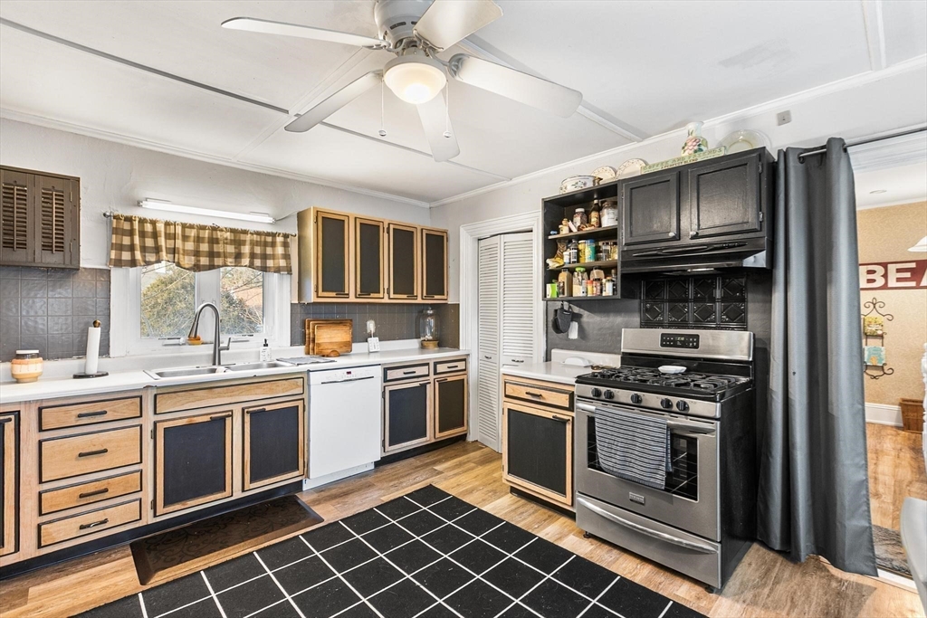 61 Church Street Merrimac, MA 01860 - Photo 10 of 32 a kitchen with a stove a sink and a microwave