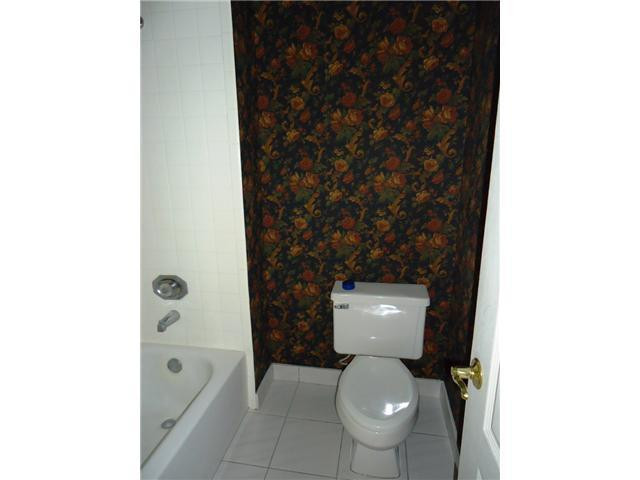 21218 Lago Circle, Unit B Boca Raton, FL 33433 - Photo 17 of 25 a white toilet sitting next to a bathroom sink