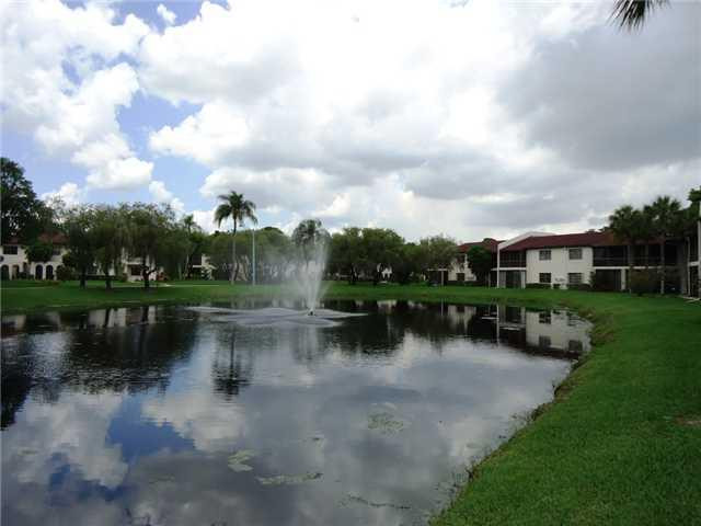 21218 Lago Circle, Unit B Boca Raton, FL 33433 - Photo 22 of 25 a view of a lake with houses in the back