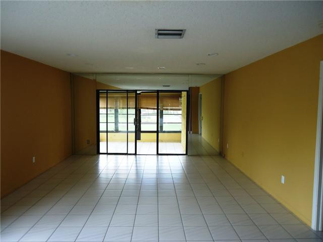 21218 Lago Circle, Unit B Boca Raton, FL 33433 - Photo 4 of 25 a view of an empty room with glass door