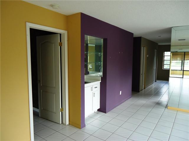 21218 Lago Circle, Unit B Boca Raton, FL 33433 - Photo 6 of 25 a view of a hallway with wooden shelves