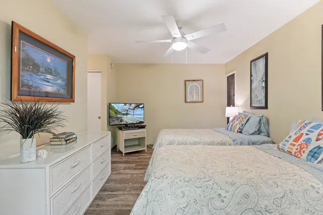 a spacious bedroom with a bed and a chandelier