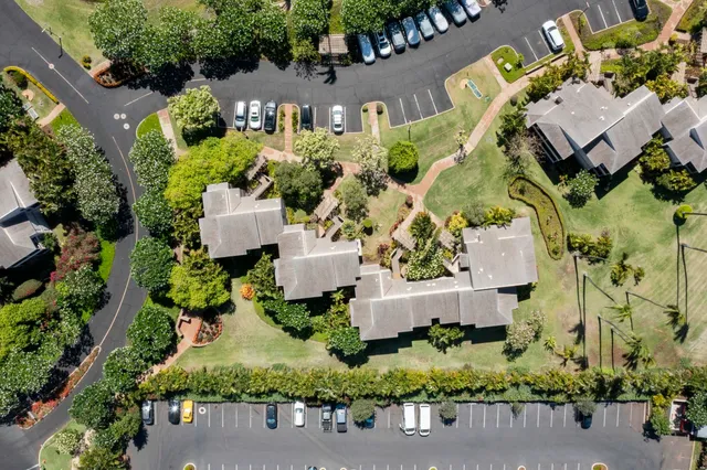 an aerial view of a house with a garden and swimming pool