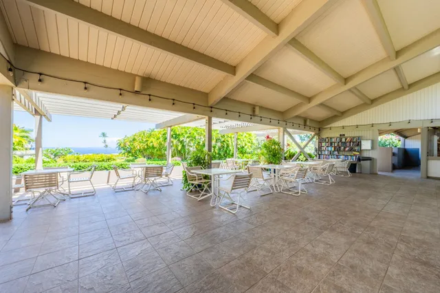 a view of a patio with table and chairs potted plants