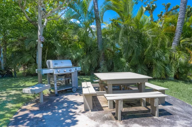 a view of a patio with a table chairs and a fire pit