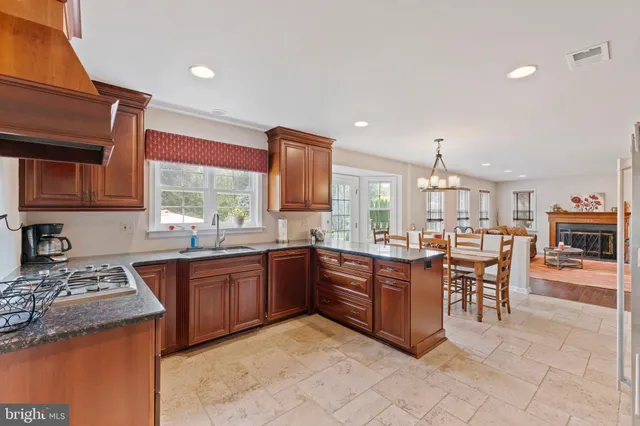 a view of kitchen with stainless steel appliances granite countertop cabinets and bed