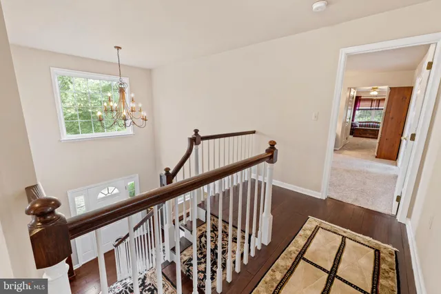 a spacious bedroom with a bed and a chandelier