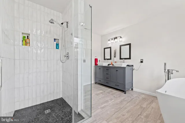 a view of walk in closet with clothes