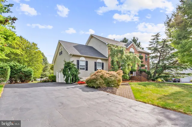 a view of a chair and table in backyard of the house