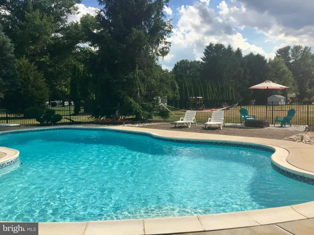 an aerial view of residential house with outdoor space and swimming pool
