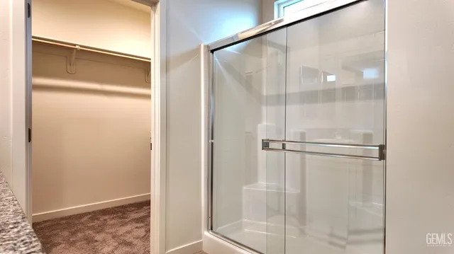 a bathroom with a glass shower door