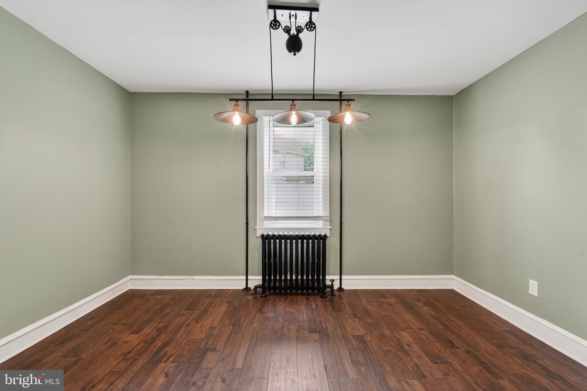 223 Noreg Place Brooklawn, NJ 08030 - Photo 15 of 36 an empty room with wooden floor and windows