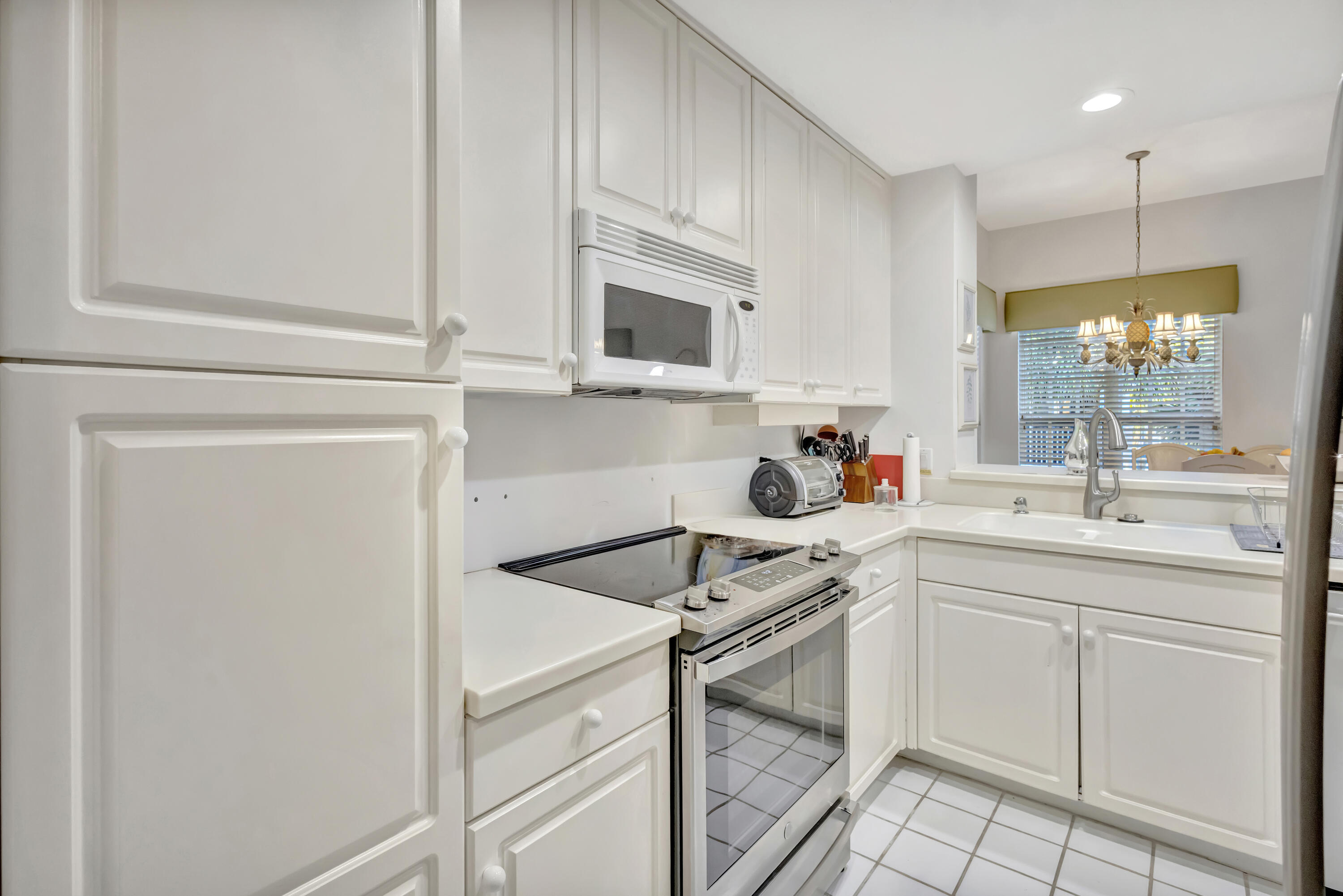 411 Northeast Plantation Road, Unit 522 Stuart, FL 34996 - Photo 11 of 52 a kitchen with a sink cabinets and appliances