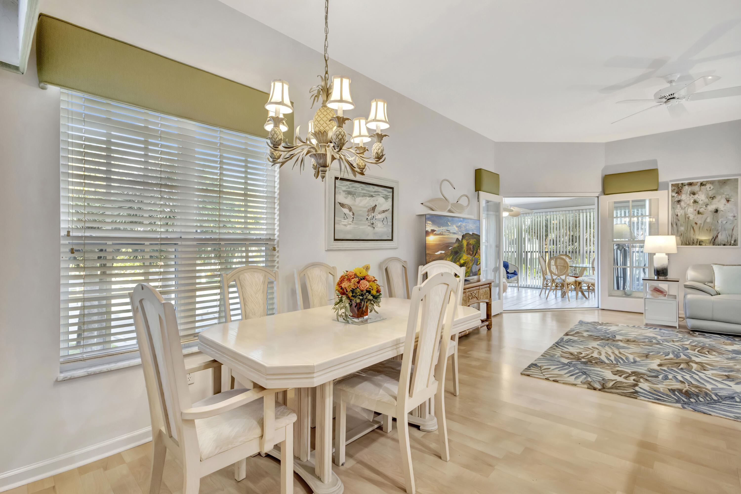 411 Northeast Plantation Road, Unit 522 Stuart, FL 34996 - Photo 14 of 52 a view of a dining room with furniture wooden floor and chandelier