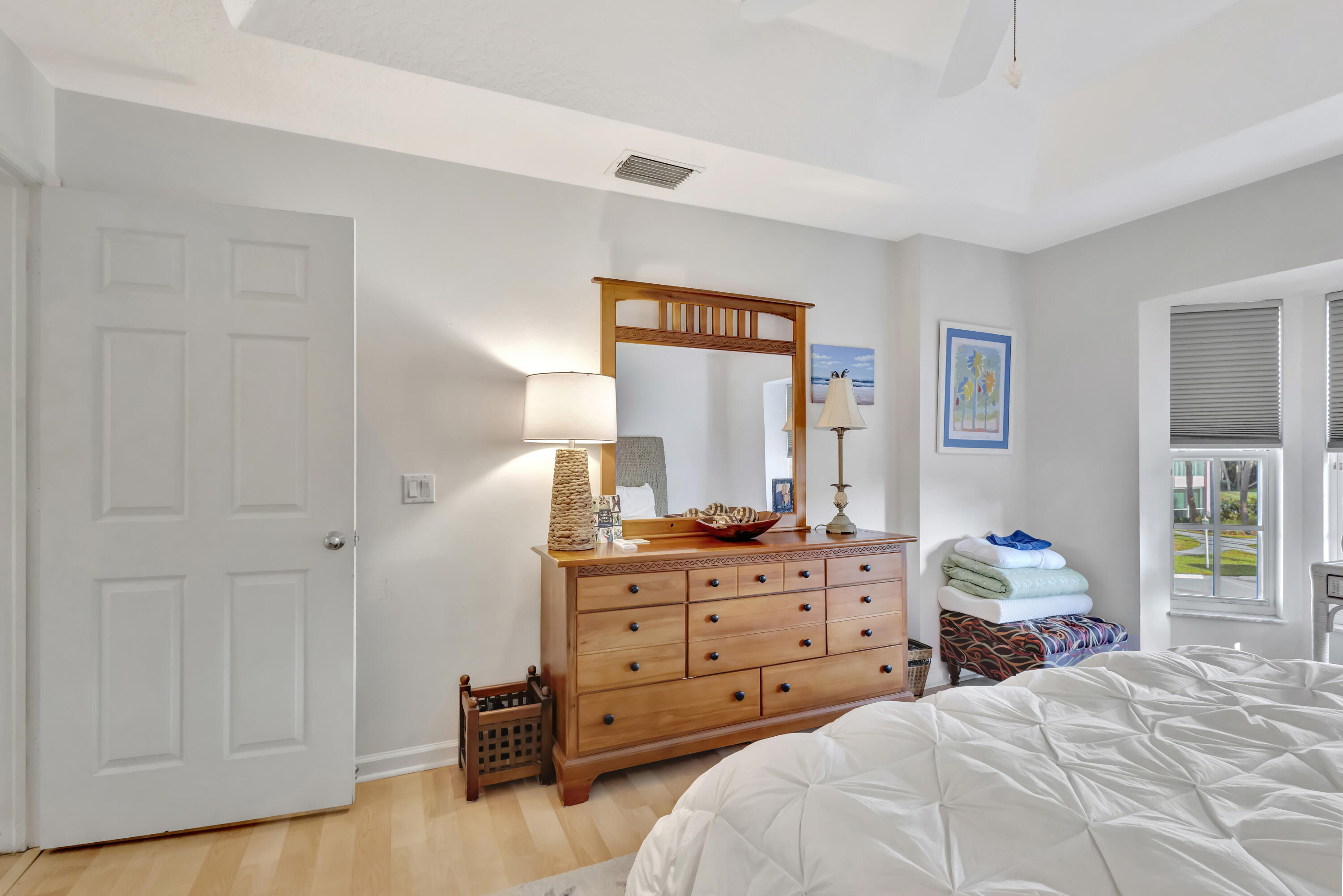 411 Northeast Plantation Road, Unit 522 Stuart, FL 34996 - Photo 16 of 52 a bedroom with a bed and a dresser