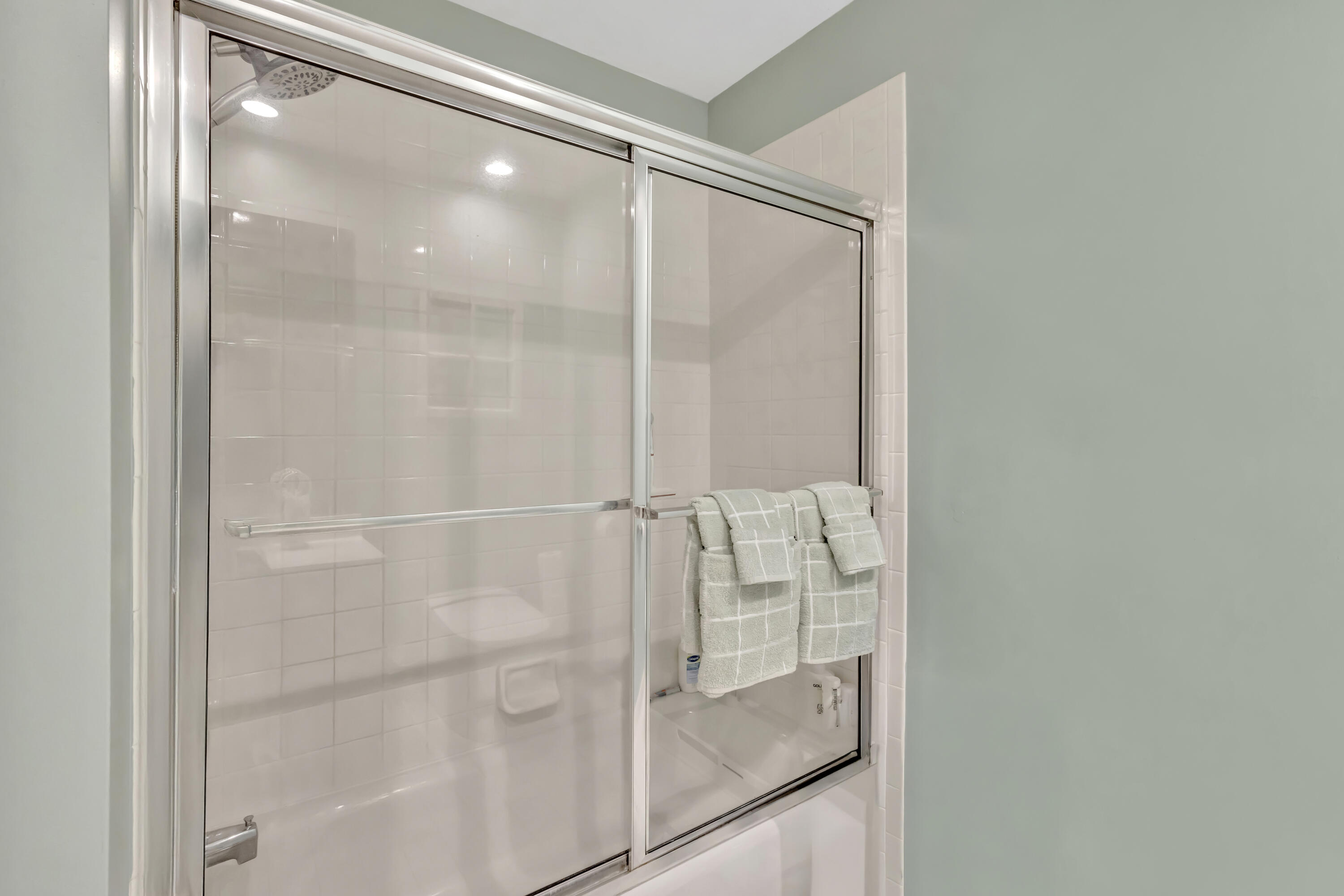 411 Northeast Plantation Road, Unit 522 Stuart, FL 34996 - Photo 18 of 52 a bathroom with a glass shower door