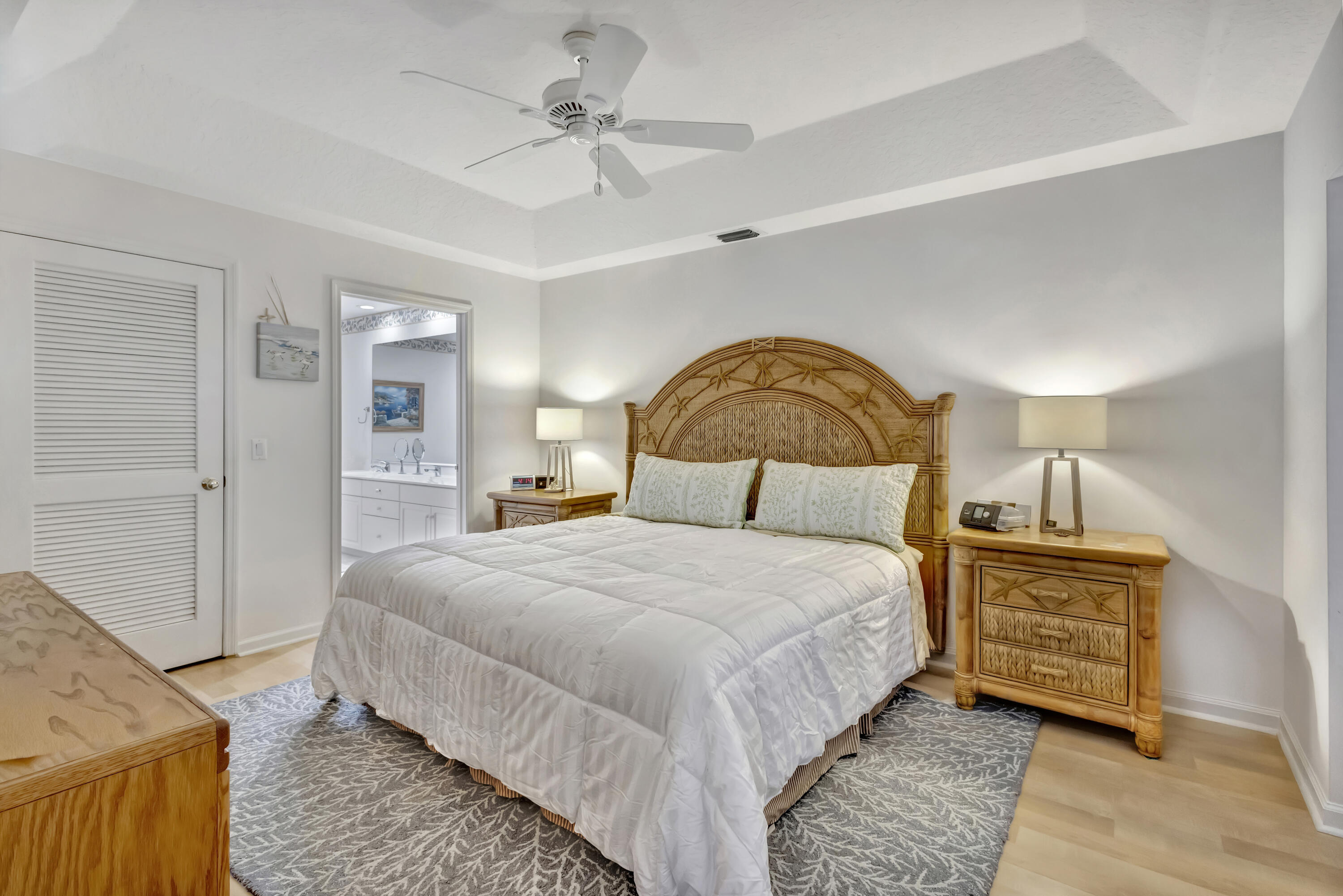 411 Northeast Plantation Road, Unit 522 Stuart, FL 34996 - Photo 19 of 52 a bedroom with a bed a dresser with wooden floor