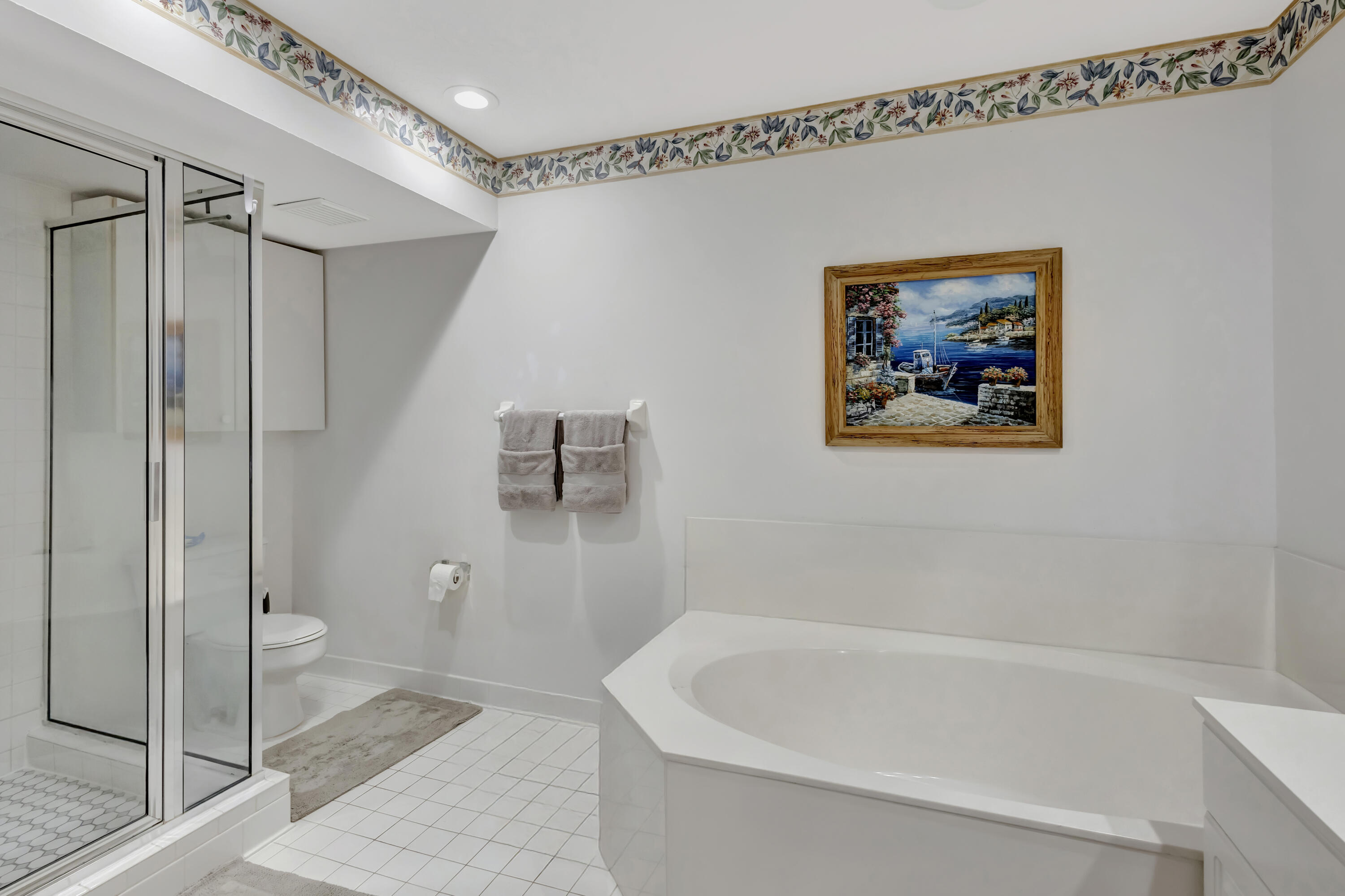 411 Northeast Plantation Road, Unit 522 Stuart, FL 34996 - Photo 23 of 52 a white bath tub sitting next to a toilet