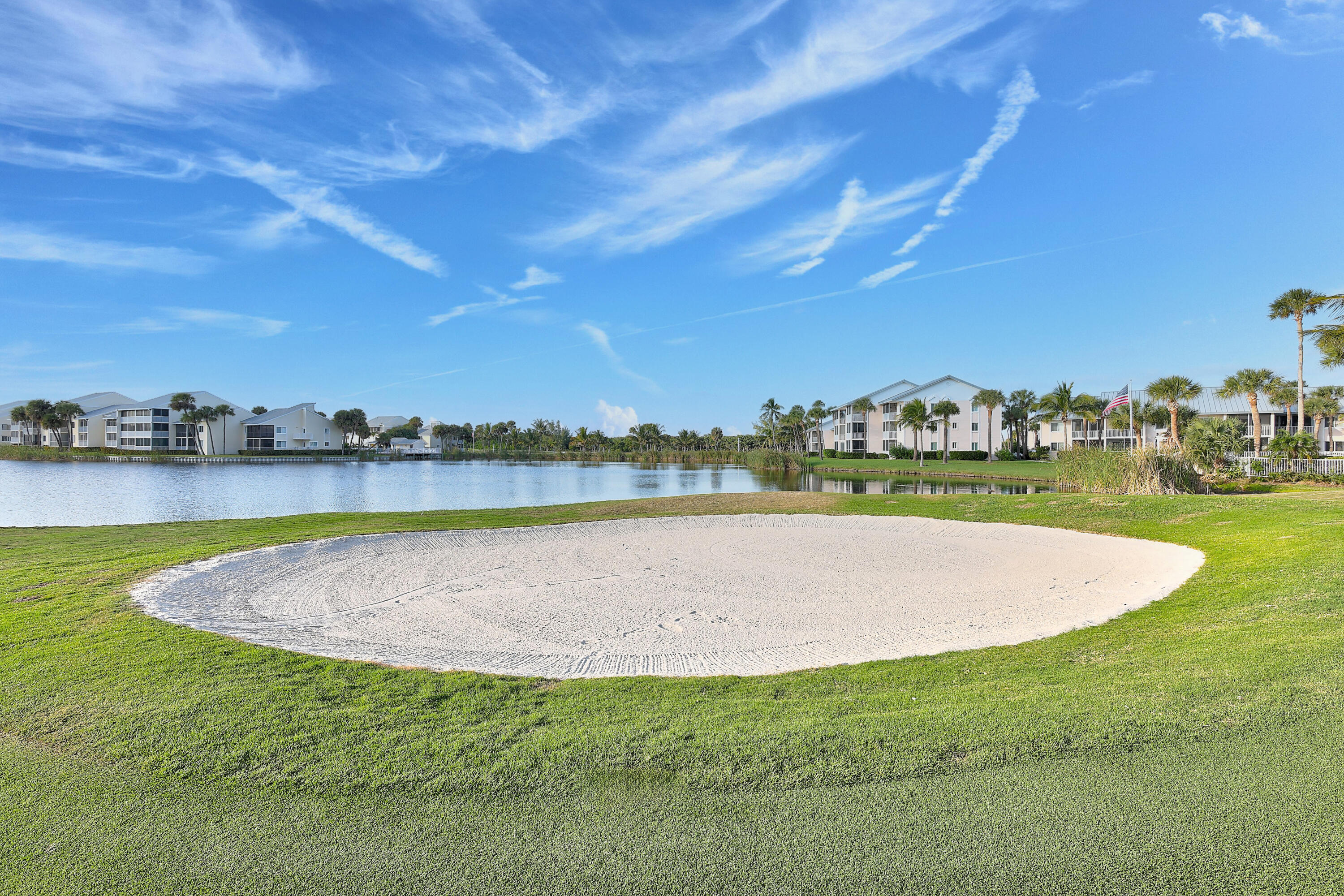 411 Northeast Plantation Road, Unit 522 Stuart, FL 34996 - Photo 32 of 52 a view of a lake with houses in the back
