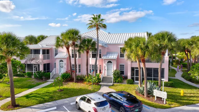 an aerial view of multiple houses with a yard