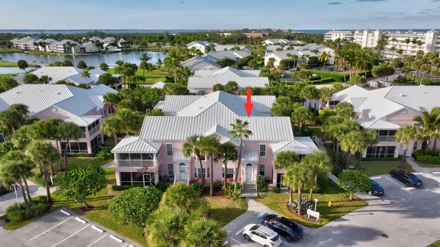 an aerial view of residential houses with outdoor space and swimming pool