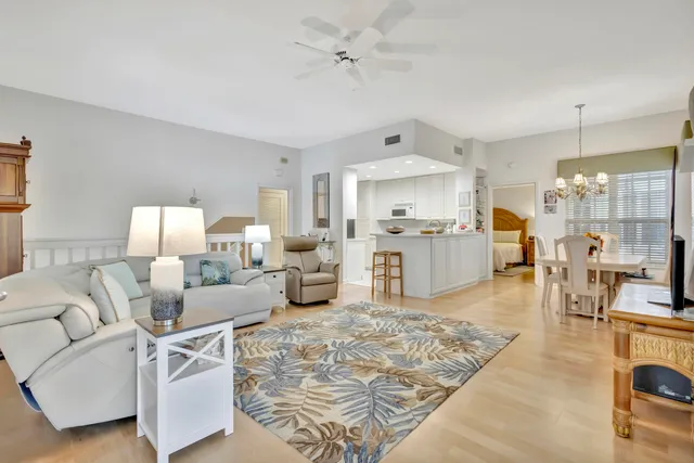 a living room with furniture and kitchen view
